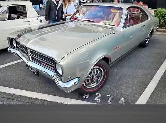 A silver Holden HK GTS Monaro at a car show