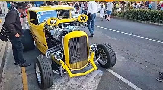 A yellow blown hot rod with twin superchargers